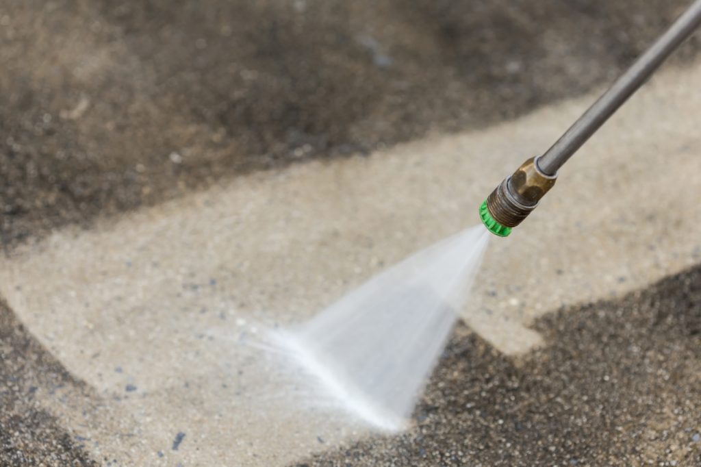 Using Pressure Washer for Cleaning Paint from Concrete 